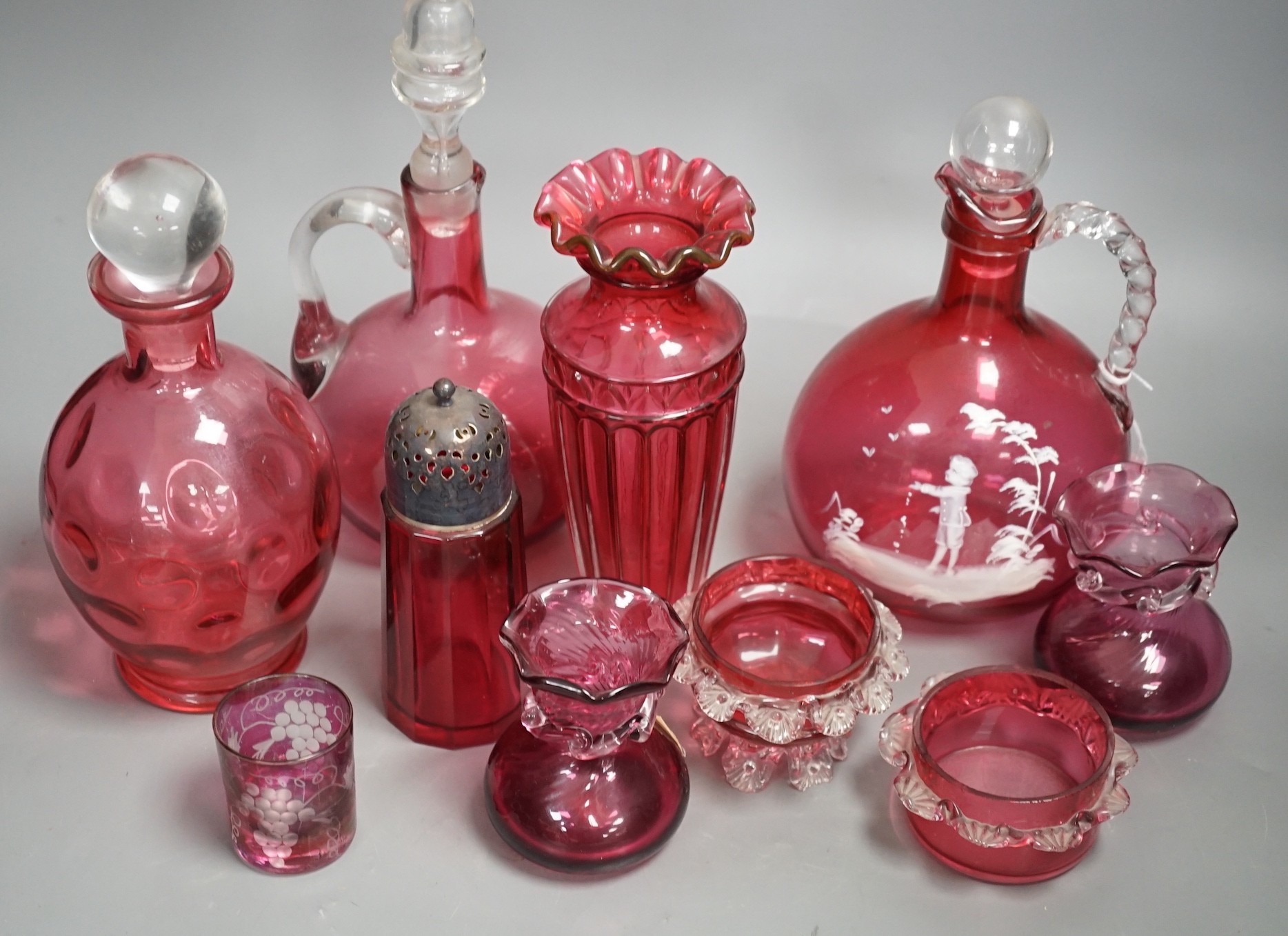 A Mary Gregory style cranberry decanter together with mixed cranberry glass (10), Mary Gregory decanter 25cms high including stopper